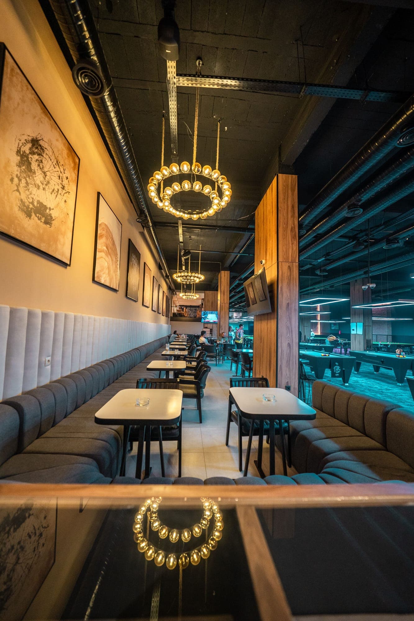 Café seating with booths overlooking the billiards hall
