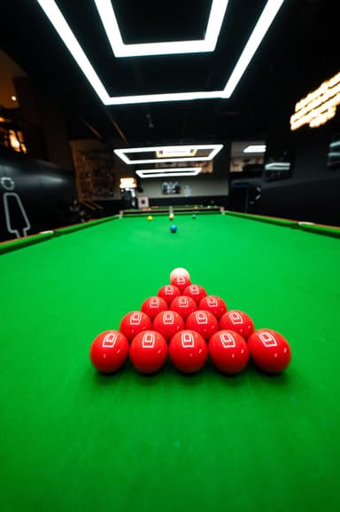 Fifteen red balls racked on a snooker table