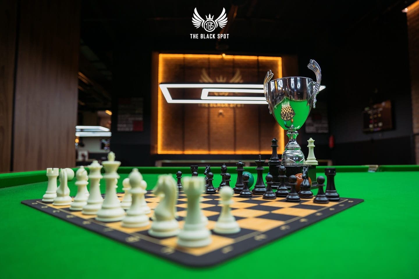 Chessboard and trophy of the Black Spot Chess Tournament on a snooker table at THE BLACK SPOT, Marrakech