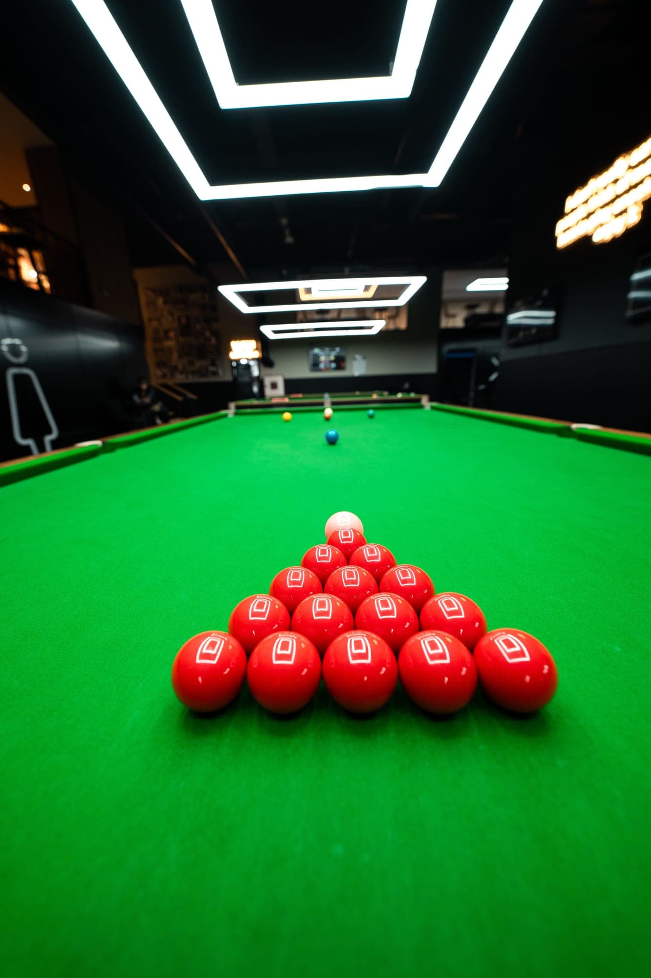 Fifteen red balls racked on a snooker table